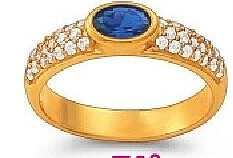 Bague dorée sertie d'une pierre bleue